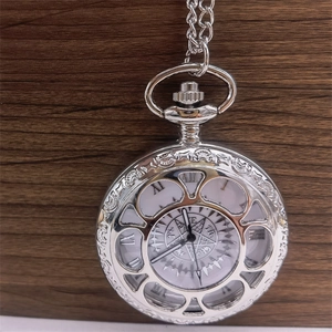 Vintage silver hollow-out pocket watch with roman numerals and chain on dark wood background