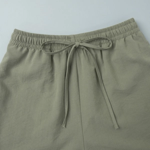 Close-up of elastic waistband with drawstring on army green linen blend shorts