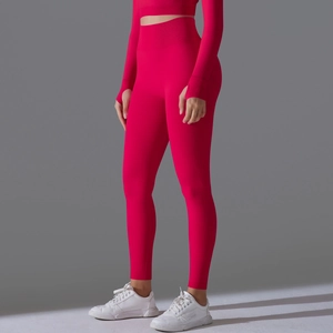 Detail of rose red seamless yoga set featuring thumb hole cuffs and high waist leggings