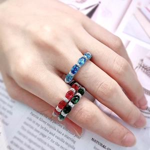 Close-up of three 925 rings with blue, red, and green gemstones and diamonds