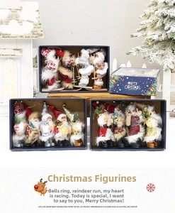 Detail of Christmas Santa dolls in a blue luxury gift box with holiday decorations