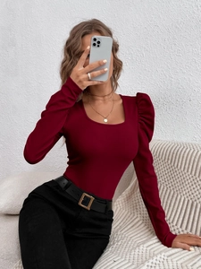 Detail of burgundy slim fit knit top with elegant mutton sleeves and square neckline
