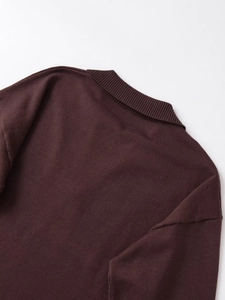 Detail of dark brown knit top featuring a ribbed collar and fine fabric texture