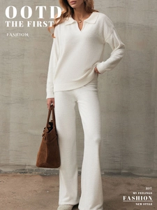 Detail of white knit polo sweater and wide-leg pants set showing soft plush texture