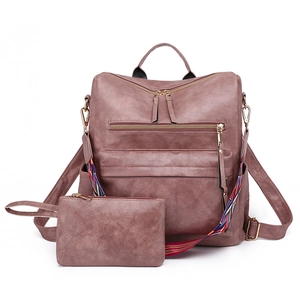 Detail of pink textured PU leather backpack set with multi-zipper pockets and woven strap