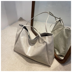 Detailed view of the off-white faux leather texture on this large casual tote bag