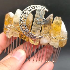 Detail of handmade natural yellow crystal hair comb with silver crescent moon and star