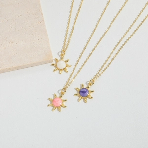 Golden sun pendant necklaces with colorful drip oil centers in white, pink, and purple