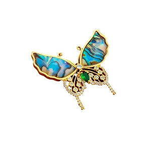 Elegant gold plated butterfly brooch with iridescent wings and green teardrop gemstone