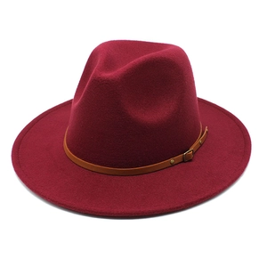 Close-up of wine red wool fedora hat with brown faux leather belt and bronze buckle