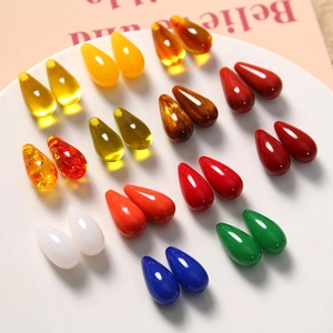 Close-up of colorful teardrop resin charms in assorted gradients for DIY jewelry making