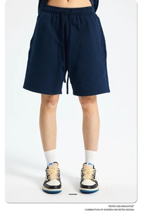 Detailed close-up of blue cotton sweat shorts with adjustable drawstring and elastic waist