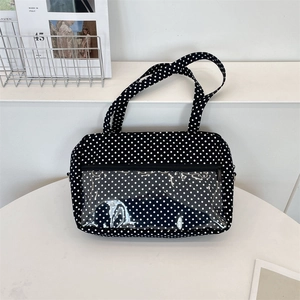 Close-up of black polka dot canvas tote bag featuring a clear PVC window and zipper pocket