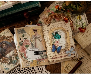Detail of vintage scrapbooking paper featuring classical ladies, butterflies and floral motifs
