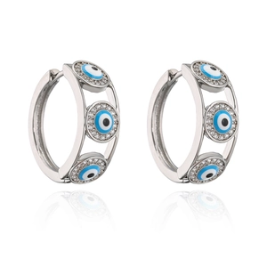Macro detail of silver hoop earrings with blue Turkish evil eye and sparkling crystals
