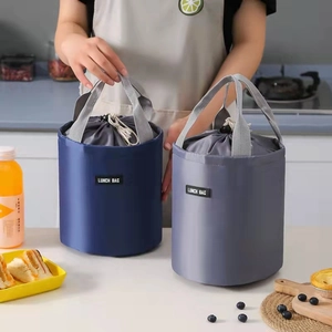 Insulated cylindrical lunch bags in blue and grey with top drawstring and sturdy handles