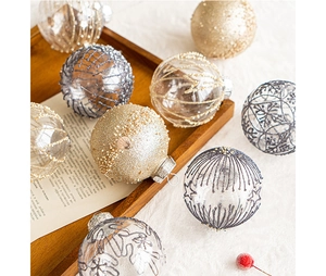 Detail of Christmas tree ornaments with gold glitter patterns and sparkling bead textures