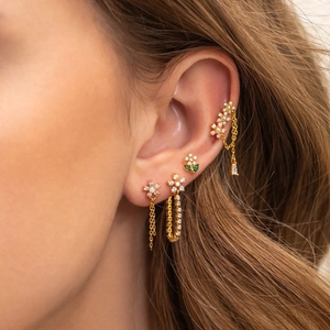 Floral earring set with zircons and pink gemstones worn on model with gold chains