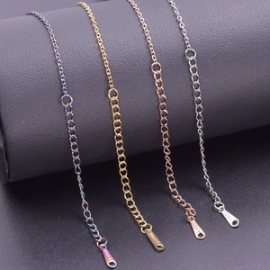 Detail view of colorful and gold stainless steel necklaces with S.STEEL material stamp