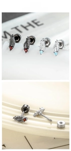 Detail view of angel wing screw back earrings in black-red and silver-blue finishes