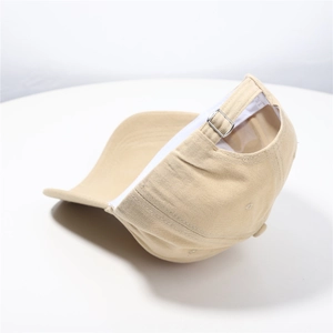 Detail of adjustable silver metal buckle and stitching on beige cotton baseball cap