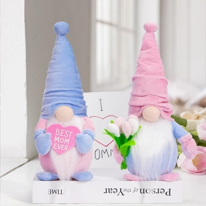 Close-up of Mother's Day gnomes on books with Best Mom Ever text and heart card