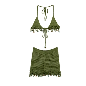 Detailed knit texture of olive green crochet set with colorful beads and fringe trim