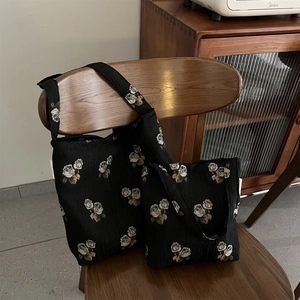 Detail of vintage black floral tote bag set with rose pattern and crinkle fabric texture