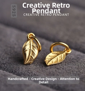 Macro detail of leaf-shaped S925 silver pendant with vintage gold plating and textures