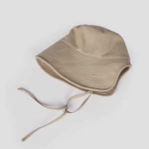 Close-up of khaki wide brim sun hat showing thick canvas texture and adjustable drawstring