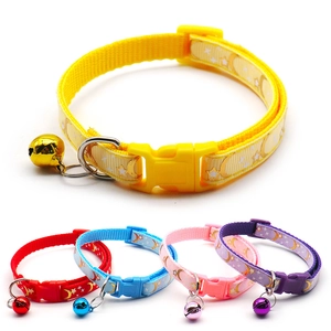 Close-up of durable nylon pet collars with golden star patterns and colorful bells