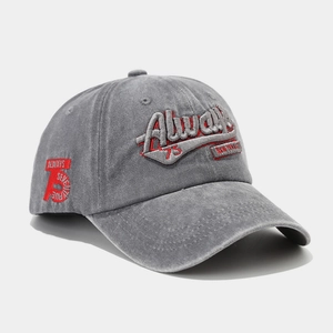 Detailed close-up of red 3D embroidery and vintage washed cotton fabric on baseball cap