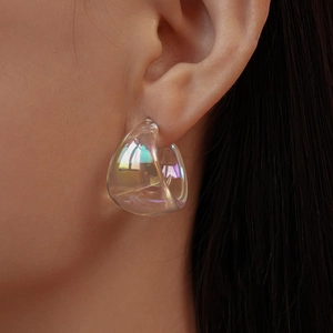 Close-up of iridescent chunky hoop earring showing reflective colorful light effects