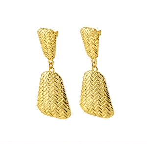 Detail view of gold-plated earrings showing unique herringbone texture and geometric pattern