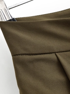 Close-up of olive green high waisted wide leg pants showing twill fabric and stitching