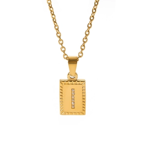 Close-up of golden rectangular pendant with vertical pavé zircon setting on gold chain