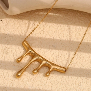 Close-up of a gold-plated liquid metal waterfall pendant with a minimalist chain