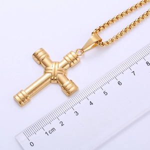 Macro view of 18k gold plated stainless steel dumbbell cross pendant with size ruler