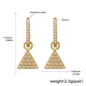 Macro detail of 18k gold plated stainless steel triangle earrings with zircon stones