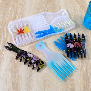Silicone molds and finished resin combs with dried flowers and glitter on wood