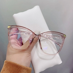Close-up of stylish pink transparent cat-eye frame glasses with metal hinge details