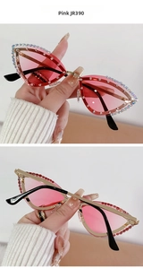 Detailed macro view of pink cat-eye sunglasses with sparkly rhinestone-encrusted metal frames