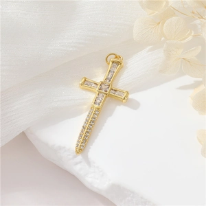 Detailed view of a vintage 14K gold-plated cross pendant with sparkling zircon inlays