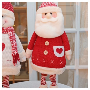 Detailed view of plush Santa and snowman dolls with knitted hats and red heart details