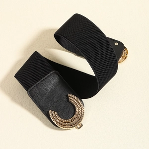 Detailed view of the gold-tone C-shaped buckle with textured finish on black elastic belt