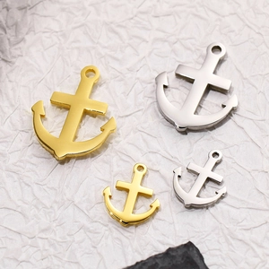 Detail of anchor pendants in gold and silver finishes in both large and small sizes