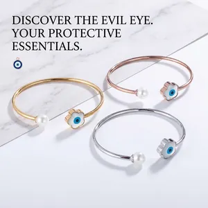 Detailed view of open bangles in gold, silver, and rose gold with evil eye and pearls