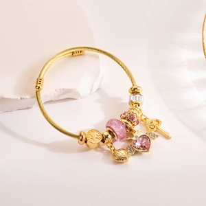Gold braided adjustable bangle with pink heart crystal and crown key charms