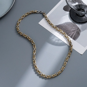 Close-up of 5mm two-tone titanium steel Byzantine chain with silver and gold links