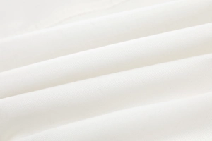 Macro detail of white twill fabric texture for a high-quality short sleeve jumpsuit